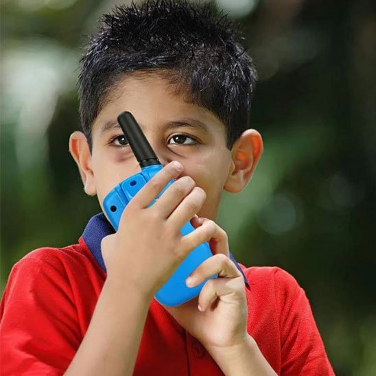 Jeune garcon qui utilise son talkie walkie enfant 
